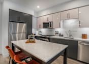 Thumbnail 1 of 25 - a kitchen with stainless steel appliances and a marble counter top
