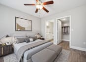Thumbnail 12 of 33 - a bedroom with a large bed and a ceiling fan