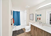 Thumbnail 5 of 30 - a bathroom with a large mirror and a toilet and a sink