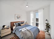 Thumbnail 4 of 30 - a bedroom with a bed and a large window