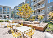 Thumbnail 23 of 37 - an outdoor patio with tables and chairs