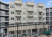 Thumbnail 18 of 20 - Apartment building with balconies and a pool.