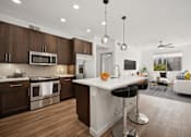 Thumbnail 1 of 24 - a kitchen and living room with a large white counter top