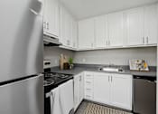 Thumbnail 4 of 21 - a kitchen with stainless steel appliances and white cabinets