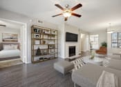 Thumbnail 10 of 33 - a living room with a fireplace and a ceiling fan