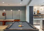 Thumbnail 13 of 25 - A pool table with a few balls on it in a room.