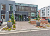 Thumbnail 34 of 34 - the front of a building with a sidewalk and planters