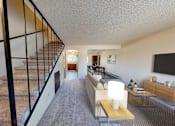Thumbnail 4 of 15 - a living room with a staircase and a tv