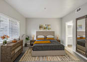 Thumbnail 4 of 18 - a bedroom with a bed and a mirror