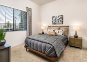 Thumbnail 6 of 24 - a bedroom with a bed and a window with blinds