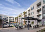 Thumbnail 19 of 24 - our apartments have a large patio with tables and chairs and a pool