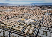 Thumbnail 17 of 20 - A large, sprawling residential area with a mountain range in the distance.