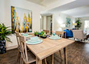 Thumbnail 5 of 20 - A dining room with a wooden table and chairs.