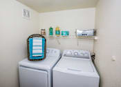 Thumbnail 8 of 20 - A laundry room with a washer and dryer and a basket on top of the washer.