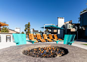 Thumbnail 10 of 27 - a fire pit with chairs and umbrellas on a patio