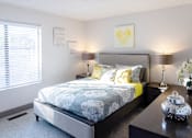 Thumbnail 3 of 27 - a bedroom with a bed and a night stand and a window