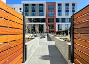 Thumbnail 27 of 30 - a view through a wooden gate into a courtyard with buildings