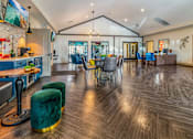 Thumbnail 11 of 27 - a clubhouse with a dining area and a kitchen with a table and chairs