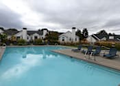 Thumbnail 16 of 32 - the view of a large swimming pool with chairs