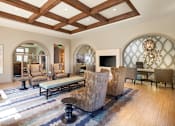 Thumbnail 14 of 21 - A living room with a large rug and a chandelier.