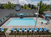 Thumbnail 10 of 18 - Sparkling pool with sun deck at Marina Village Apartments, NV 89434