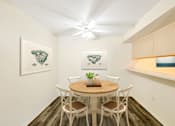 Thumbnail 1 of 29 - a dining room with a table and chairs and a ceiling fan