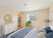 Thumbnail 10 of 29 - a bedroom with a bed and a dresser and a window