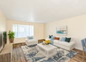Thumbnail 12 of 29 - a living room with a white couch and a coffee table