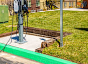 Thumbnail 5 of 29 - a gas pump sitting next to a street sign in front of some houses