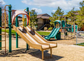 Thumbnail 17 of 29 - a playground with a slide and other playground equipment