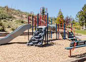 Thumbnail 16 of 29 - a playground with slides and benches in a park