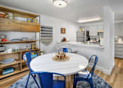 Thumbnail 4 of 27 - A kitchen with a dining table and chairs.