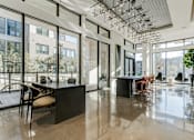 Thumbnail 14 of 23 - a large room with large windows and a table and chairs