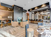 Thumbnail 10 of 23 - a lounge area with tables and chairs and a fireplace