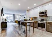 Thumbnail 1 of 23 - an open kitchen and living room with a table and chairs