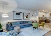 Thumbnail 3 of 23 - a living room with a blue couch and a round table