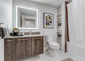 Thumbnail 5 of 23 - a bathroom with a toilet and a shower and a sink