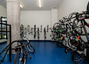 Thumbnail 18 of 26 - a room full of bikes and a wall with a row of bicycles on it