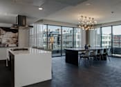 Thumbnail 16 of 26 - a kitchen and dining area with a large window and a table with chairs