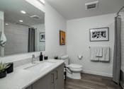 Thumbnail 4 of 26 - a bathroom with a sink and a toilet and a shower