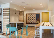 Thumbnail 13 of 26 - a kitchen with a bar and a table with blue stools