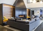 Thumbnail 14 of 26 - a living room with a couch and a fireplace