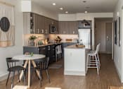 Thumbnail 2 of 26 - a view of a kitchen and a dining room with a table and chairs