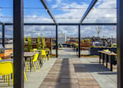 Thumbnail 22 of 26 - the roof terrace with tables and chairs and a view of the city