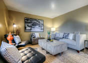 Thumbnail 6 of 16 - A living room with a black leather chair and a white couch.