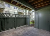Thumbnail 4 of 16 - A balcony with a lattice fence and a green door.