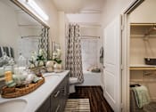 Thumbnail 10 of 24 - A bathroom with a white sink and a mirror.