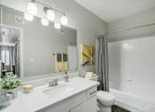 Thumbnail 17 of 33 - a bathroom with a large mirror and a sink and a toilet