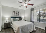 Thumbnail 16 of 33 - a bedroom with a bed and a ceiling fan