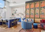 Thumbnail 38 of 41 - a view of a room with a wall filled with colorful quilts and chairs